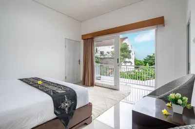 a bedroom with a bed and a balcony at Q LE Villa 2 is 2BR Villa with Private Pool in Seminyak in Seminyak