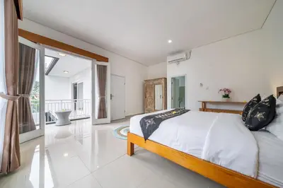 a bedroom with a bed and a large window at Q LE Villa 2 is 2BR Villa with Private Pool in Seminyak in Seminyak