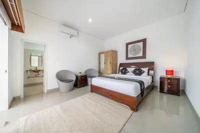 a bedroom with a large bed and a bathroom at Q LE Villa 2 is 2BR Villa with Private Pool in Seminyak in Seminyak