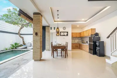 a kitchen and dining room with a table and a swimming pool at Q LE Villa 2 is 2BR Villa with Private Pool in Seminyak in Seminyak