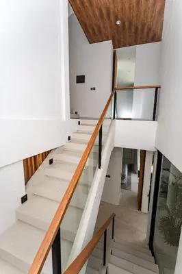 a staircase in a house with glass railings at Luxury 4BR Villa - Pool Rooftop Berawa Canggu in Balian