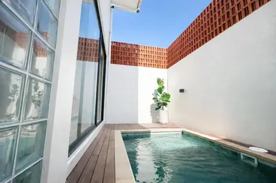 an indoor swimming pool in the middle of a house at Private Pool Villa Near Uluwatu in Jimbaran