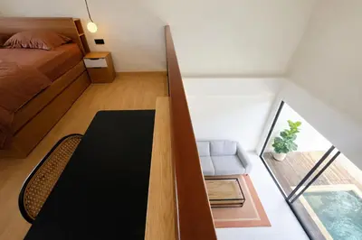 a small room with a table and a bed at Private Pool Villa Near Uluwatu in Jimbaran