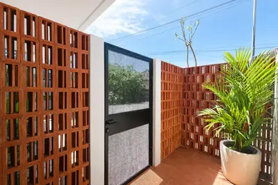 an open door to a balcony with a plant at Private Pool Villa Near Uluwatu in Jimbaran