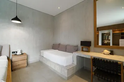 a bedroom with a white bed and a mirror at Villa Kalooka by BaliSuperHost in Seminyak