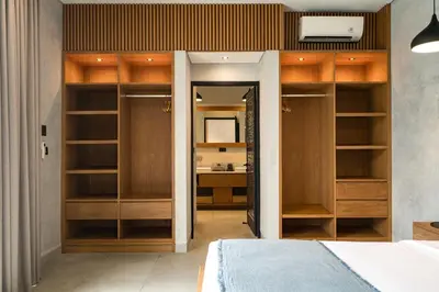 a bedroom with wooden shelves and a bed at Villa Kalooka by BaliSuperHost in Seminyak