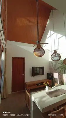 a living room with two lights and a tv at Palm Harmony Villa's Seminyak in Seminyak