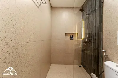 a shower with a glass door in a bathroom at Hummingbird Villa by Bukit Vista in Kerobokan