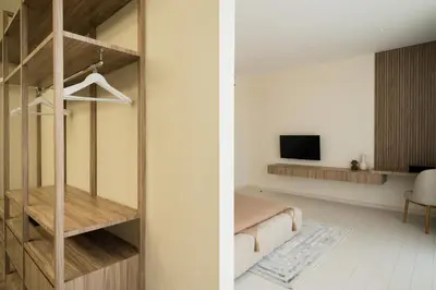 a bedroom with a bed and a tv in a room at Private Romantic Pool 1bd Villa in Seminyak in Seminyak