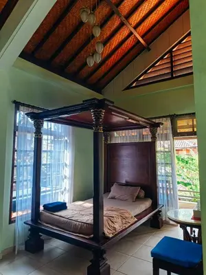 a bedroom with a canopy bed in a room at Widi House in Nusa Dua