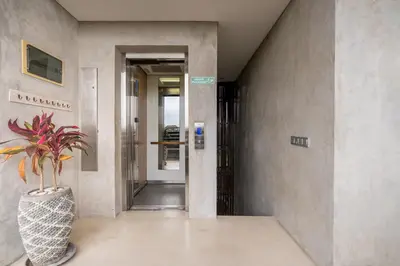 a hallway with a plant in a vase in a building at Duur Apartment by Betterplace in Seminyak