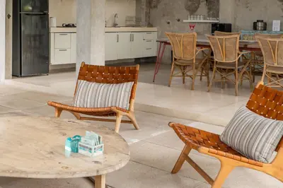 a kitchen with two chairs and a table with at Duur Apartment by Betterplace in Seminyak