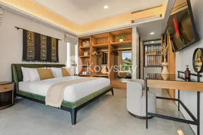 a bedroom with a bed and a desk at Niskala Villa by Kozystay - Natadesa Resort in Jimbaran