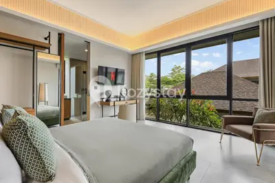 a bedroom with a bed and a large window at Niskala Villa by Kozystay - Natadesa Resort in Jimbaran