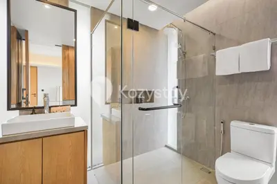 a bathroom with a shower and a toilet and a sink at Niskala Villa by Kozystay - Natadesa Resort in Jimbaran