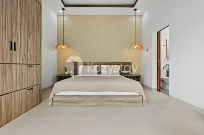 a bedroom with a large bed and two lights at Surbiton Villa by Kozystay - Seminyak in Seminyak