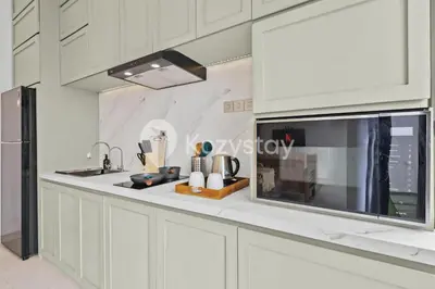 a kitchen with white cabinets and a sink at Surbiton Villa by Kozystay - Seminyak in Seminyak