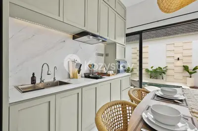 a kitchen with a sink and a table with chairs at Surbiton Villa by Kozystay - Seminyak in Seminyak