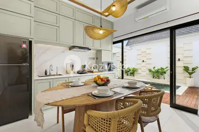 a kitchen with a table with a bowl of fruit on it at Surbiton Villa by Kozystay - Seminyak in Seminyak
