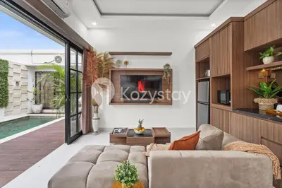 a living room with a couch and a tv at Biyan Villa by Kozystay - Seminyak in Seminyak