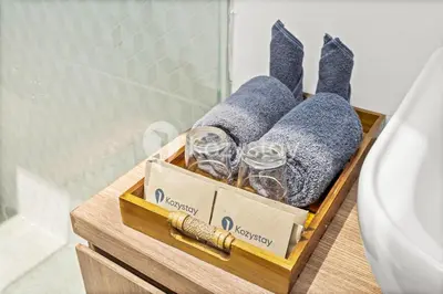 a wooden box with glasses and towels in a bathroom at Biyan Villa by Kozystay - Seminyak in Seminyak