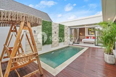a villa with a swimming pool and a hammock at Biyan Villa by Kozystay - Seminyak in Seminyak
