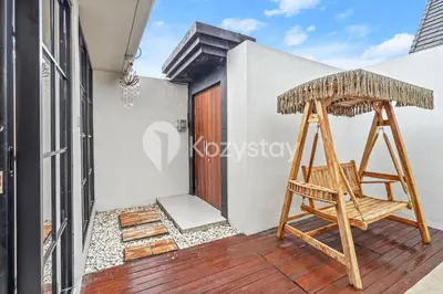 a chair on the balcony of a house at Biyan Villa by Kozystay - Seminyak in Seminyak