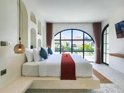 a bedroom with a large bed with a large window at Villa Emilia Canggu by Nagisa Bali in Canggu