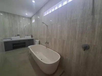 a bathroom with a bath tub and a sink at Villa umalas in Seminyak