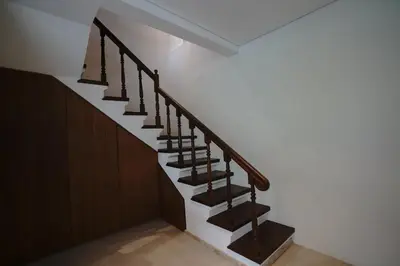a staircase in a house with wooden railings at Juan Villa Legian in Seminyak