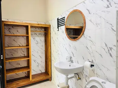 a bathroom with a sink and a mirror at Umah Kak Pasek in Jimbaran