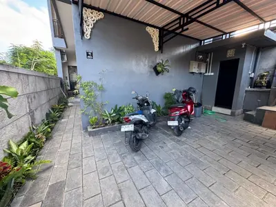 two motorcycles parked in front of a house at Umah Kak Pasek in Jimbaran