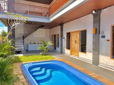 a swimming pool in the backyard of a house at Tanhana Seminyak in Kerobokan