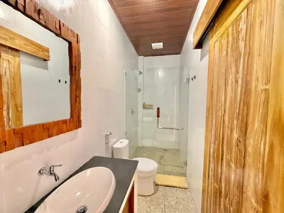 a bathroom with a sink and a toilet and a shower at Tanhana Seminyak in Kerobokan