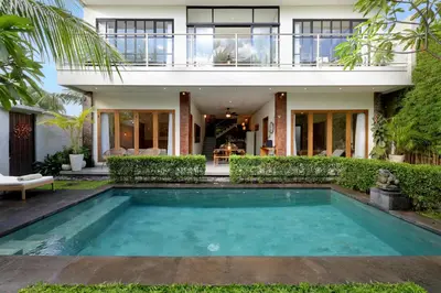 a house with a swimming pool in front of it at 6BR Seminyak Oasis with 2 Private Pools in Seminyak