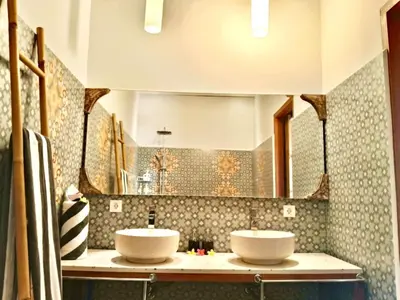 a bathroom with two sinks and a mirror at Authentic Balinese Riverside Villa in Kerobokan