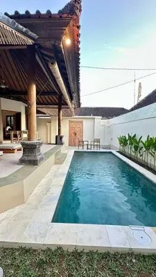 a swimming pool in the middle of a house at Authentic Balinese Riverside Villa in Kerobokan