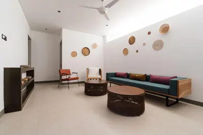 a living room with a couch and some chairs at 2 Bedroom Seminyak Apartment -1 in Seminyak