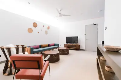 a living room with a couch and a tv at 2 Bedroom Seminyak Apartment -1 in Seminyak