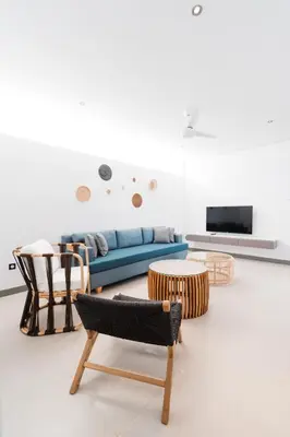 a living room with a blue couch and chairs at 2 Bedroom Seminyak Apartment -1 in Seminyak