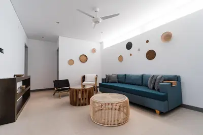 a living room with a blue couch and a table at 3 Bedroom Seminyak Apartment -3 in Seminyak