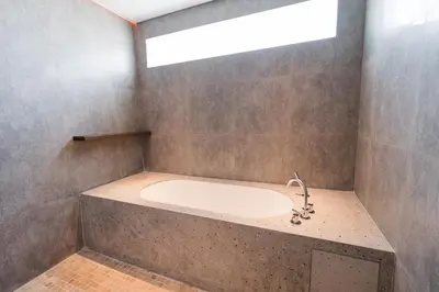 a bathroom with a bath tub with a sink at 3 Bedroom Seminyak Apartment -3 in Seminyak