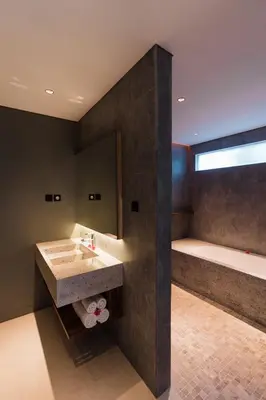a bathroom with a sink and a bath tub at 3 Bedroom Seminyak Apartment -3 in Seminyak