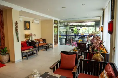 a lobby of a hotel with chairs and tables at Bali Orchid Spa in Kuta