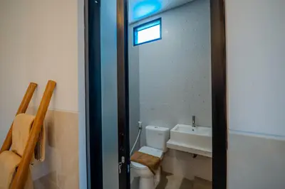 a bathroom with a toilet and a sink at Wana Kubu Suite and Dormitory in Ngurah Rai International Airport