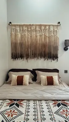 a bedroom with a bed with a curtain above it at Batara Room in Nusa Dua