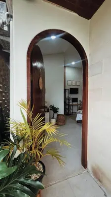 an archway leading into a room with plants at Batara Room in Nusa Dua
