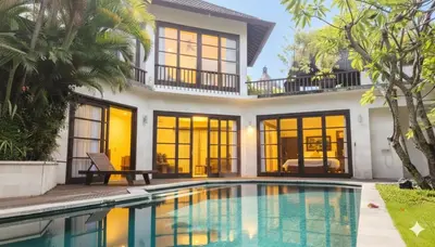a house with a swimming pool in front of it at Calladi Villa in Seminyak