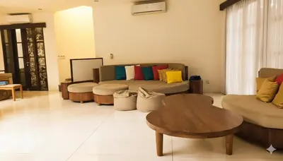 a living room with a couch and a table at Calladi Villa in Seminyak