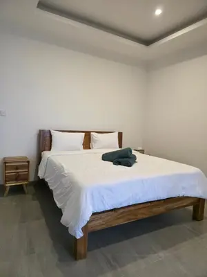 a bedroom with a large bed with white sheets at Le Calme Villa Brand New 2 BR Private Villa near Seminyak in Kerobokan